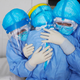 This photo taken on January 28, 2020 shows medical staff members hugging each other in an isolation ward at a hospital in Zouping in China’s easter Shandong province.